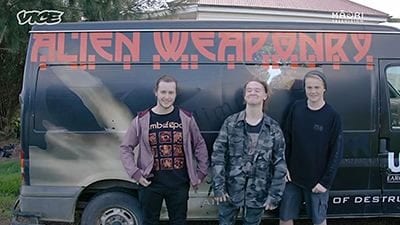 Metal music group Alien Weaponry in front of their tour van