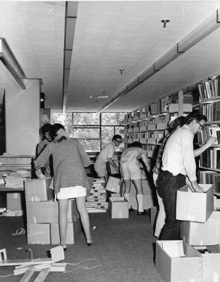 Unpacking and shelving. University of Auckland Library historical collection. MSS & Archives E-10.