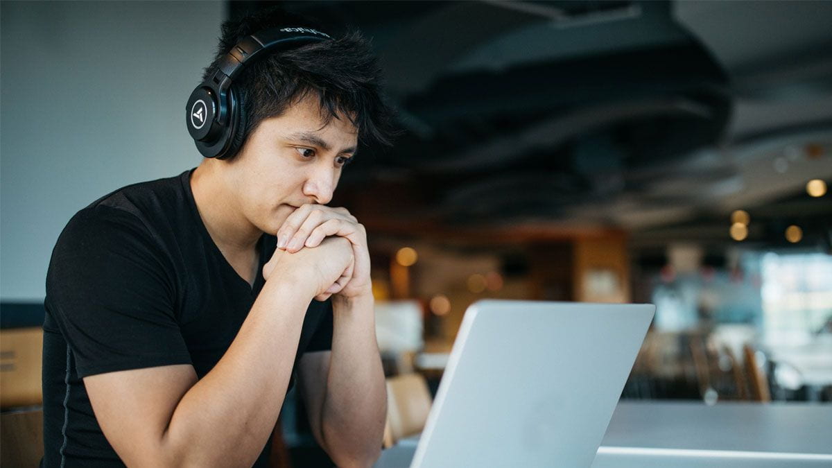 Student wearing headphones looking at a laptop