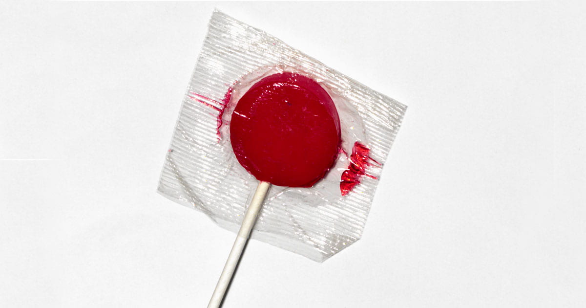 Red lollipop in plastic wrap