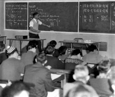 Associate Professor Mervyn Rosser demonstrates ‘walk, talk and chalk’ in an Engineering lecture from the 1960s. Photographer Anton Estie.