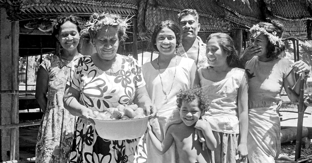 The household of Kanipule and Fosa, Nanumea, Tuvalu, 18 August 1973. (R to L) Mangao, Fosa, Lotomama, Kanipule, Vinasita, Seila, and Tiefini (in front). Photograph courtesy of Kiti (Keith Chambers) and Ane (Anne Chambers).